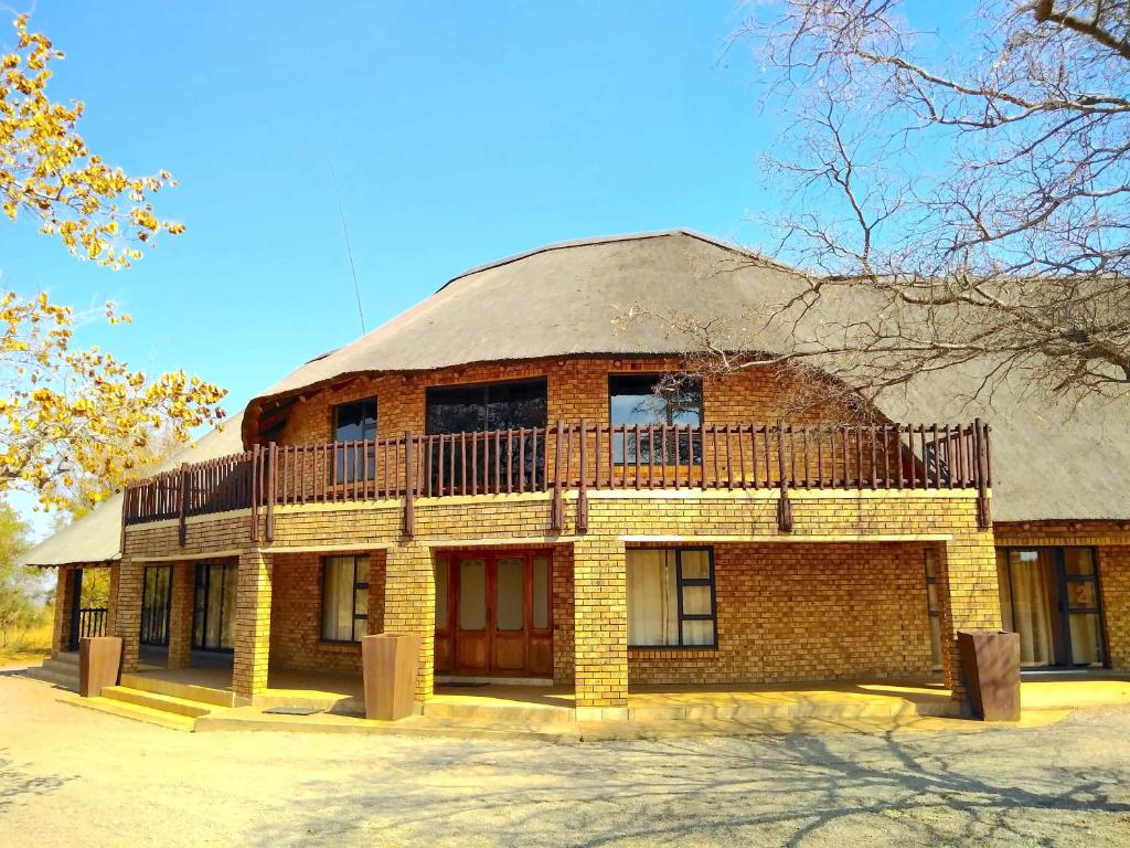a brick building with a balcony on top of it at Zebula Luxury Lodge in Mabula