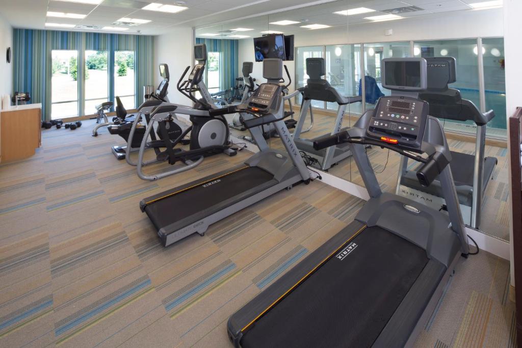 a gym with several treadmills and cardio machines at Holiday Inn Express & Suites Monroe by IHG in Monroe
