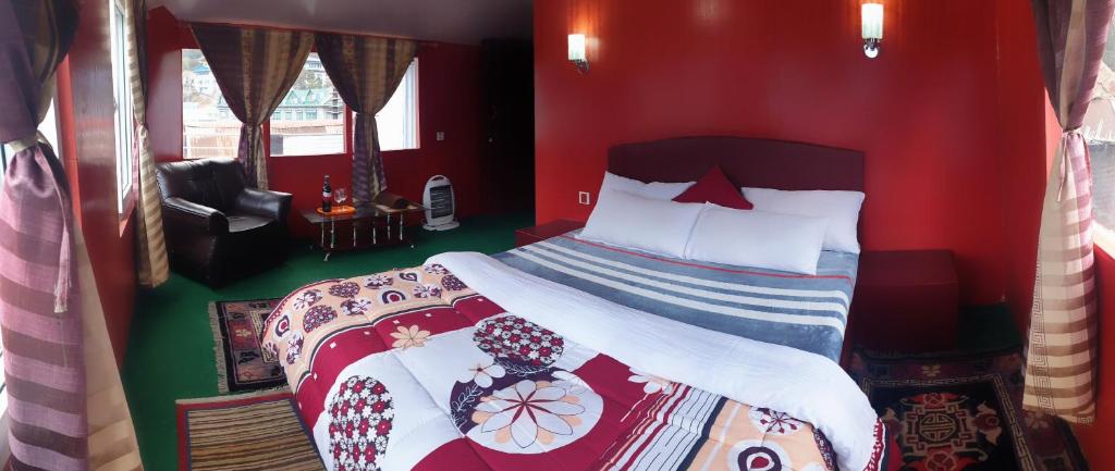 a bedroom with a bed in a red room at Lama Hotel - Cafe De Himalaya in Lukla