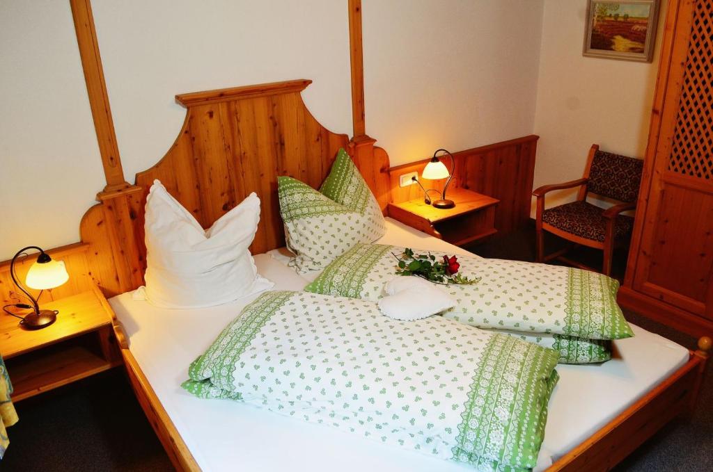 a bedroom with two beds with green and white pillows at Sonnenhof Biberwier in Biberwier