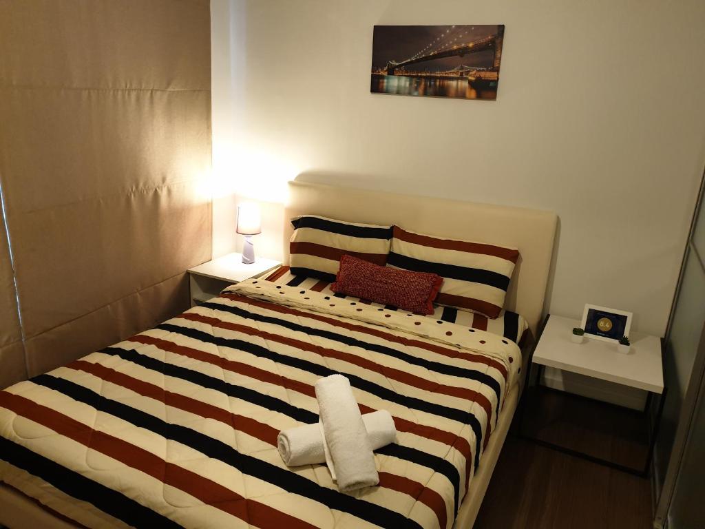 ein Schlafzimmer mit einem Bett mit zwei Handtüchern darauf in der Unterkunft The Relaxing Room Mountain View at Baan Tew Lom Condominium Cha Am - Hua Hin in Cha-am
