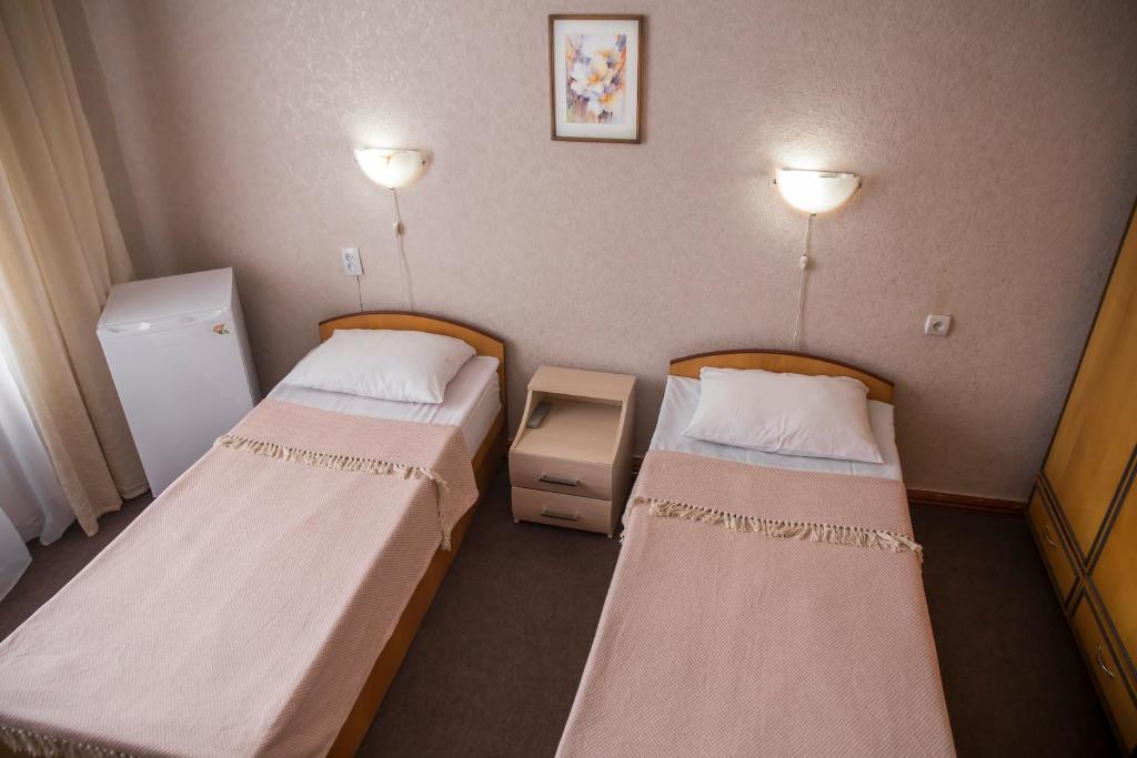 Postel nebo postele na pokoji v ubytování Chisinau Hotel