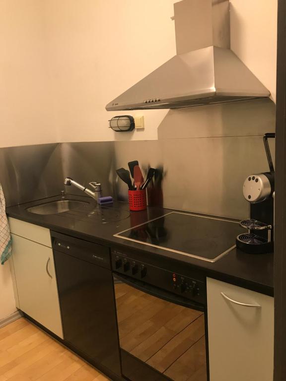 a kitchen with a sink and a stove top oven at Albergo Diffuso Porrentruy in Porrentruy