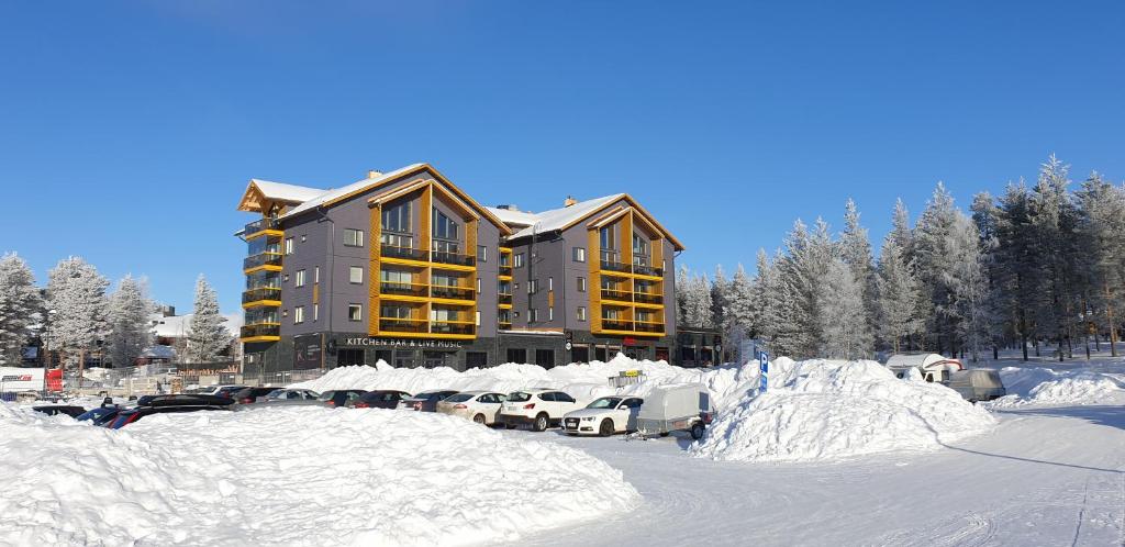 a snow covered parking lot in front of a building at Levin Kunkku C 7 in Levi