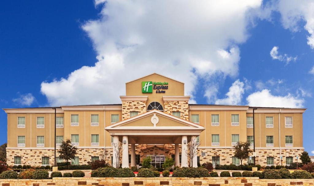 a hotel building with a sign on top of it at Holiday Inn Express & Suites Brady by IHG in Brady