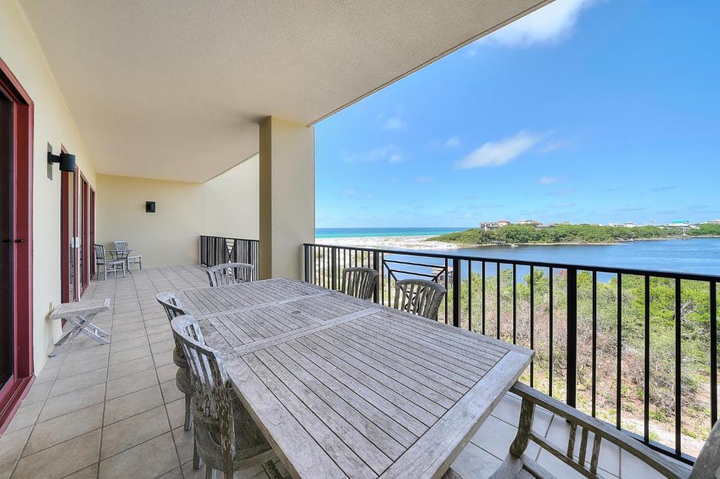 a balcony with a table and a view of the ocean at Sanctuary by the Sea Condos in Santa Rosa Beach