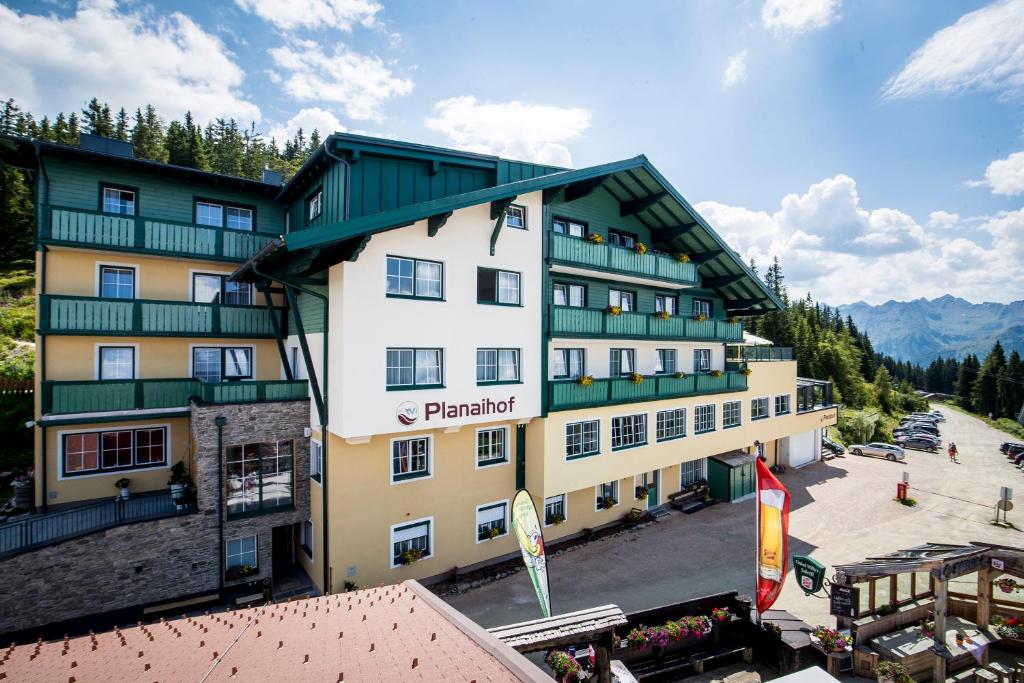 a large building with a sign on the side of it at Hotel-Restaurant Planaihof in Schladming