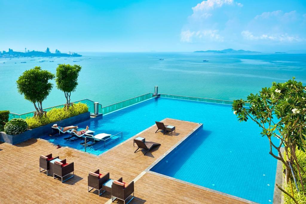 a swimming pool with a view of the water at Wongamat Tower High Floor&Seaview in Pattaya North