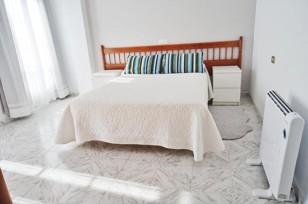 Postel nebo postele na pokoji v ubytování Vivienda de uso turístico Alma da Costa da Morte