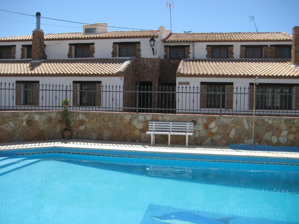 a swimming pool in front of a building at Cortijo El Rey in El Almicerán