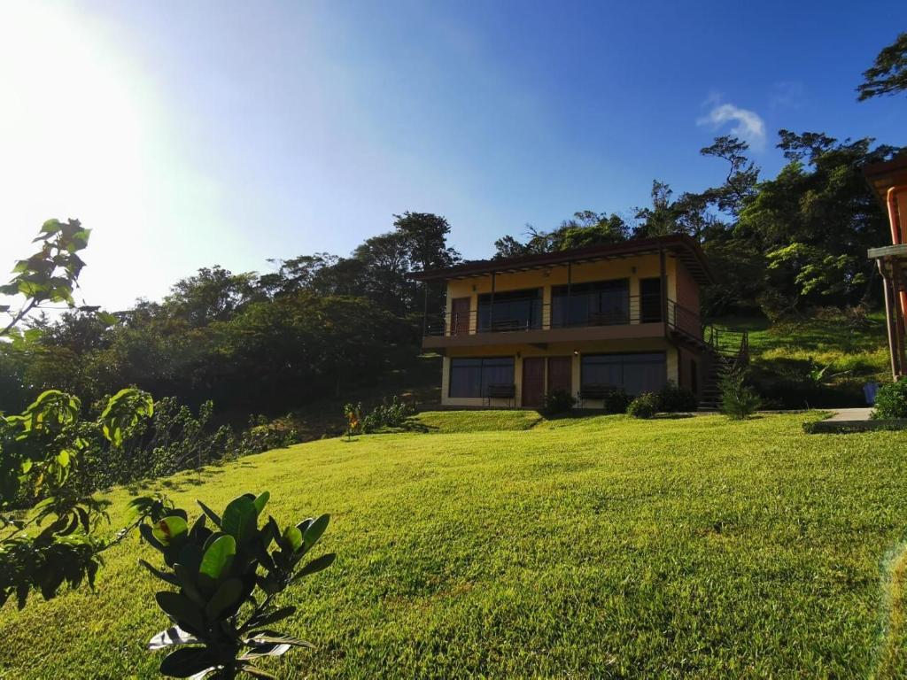 a house on a hill with a large yard at Apartment Monte Luna Mountain View in Monteverde Costa Rica