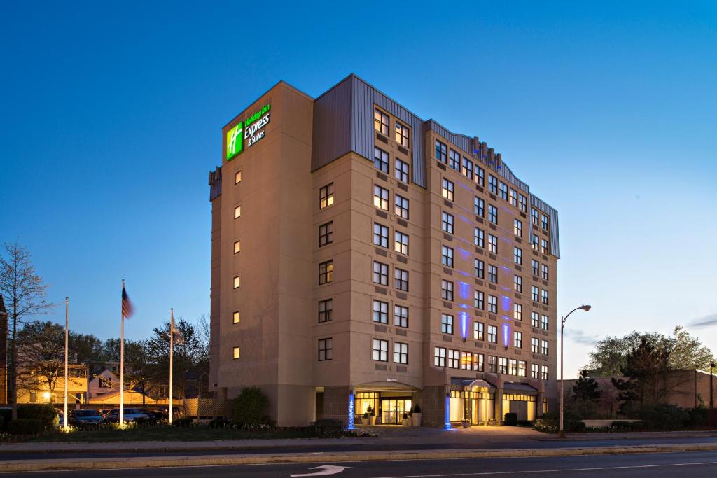 a building with a lit up sign on top of it at Holiday Inn Express & Suites Boston - Cambridge, an IHG Hotel in Cambridge