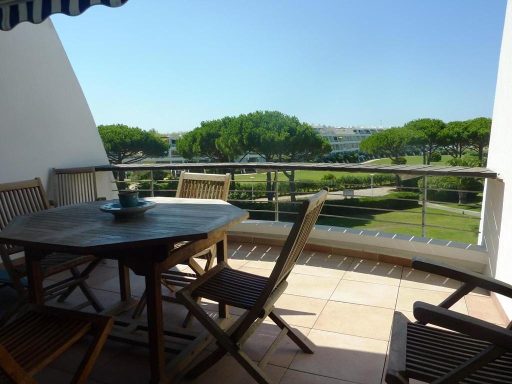 a table and chairs on a balcony with a view at AS13247 - P2 Cabine climatisé avec belle vue sur la Mer in Le Grau-du-Roi