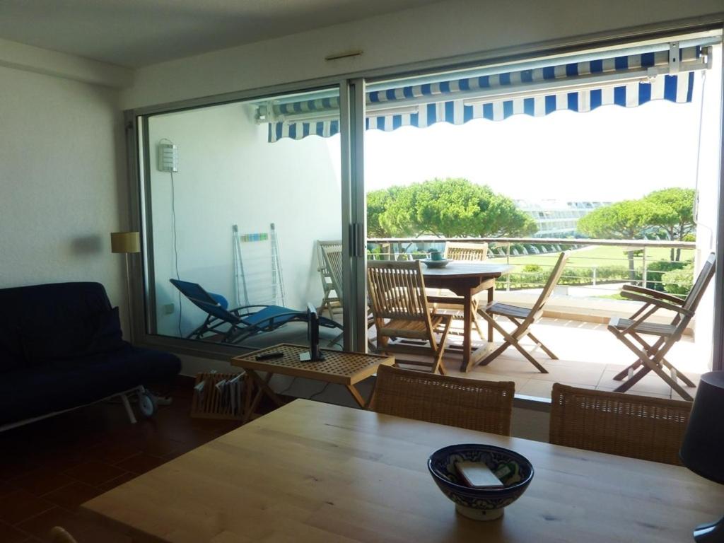 a living room with a view of a patio at AS13247 - P2 Cabine climatisé avec belle vue sur la Mer in Le Grau-du-Roi