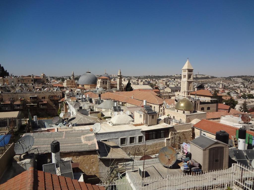 a view of a city with buildings and mosques at Jaffa Gate Hostel in Jerusalem