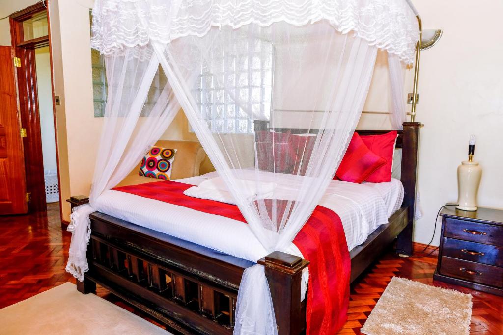 Postel nebo postele na pokoji v ubytování Orchid Homes, Gigiri