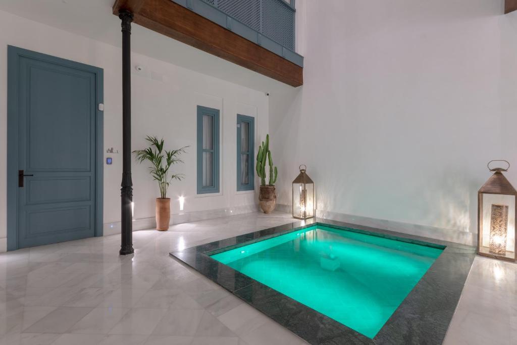 a swimming pool in the middle of a house at Apartamentos Caminante del Agua in Seville