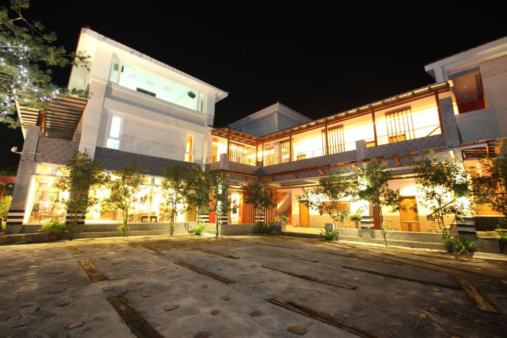 a large building with lights on at night at Zen and Pine Resort in Shuili