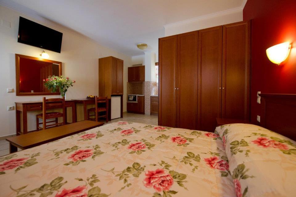 a bedroom with a large bed with flowers on it at Villa Diamond 2 in Parga