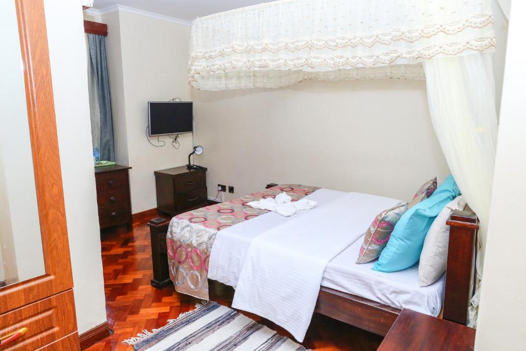 Postel nebo postele na pokoji v ubytování Orchid Homes, Gigiri