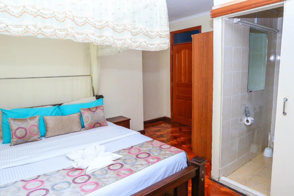 Postel nebo postele na pokoji v ubytování Orchid Homes, Gigiri