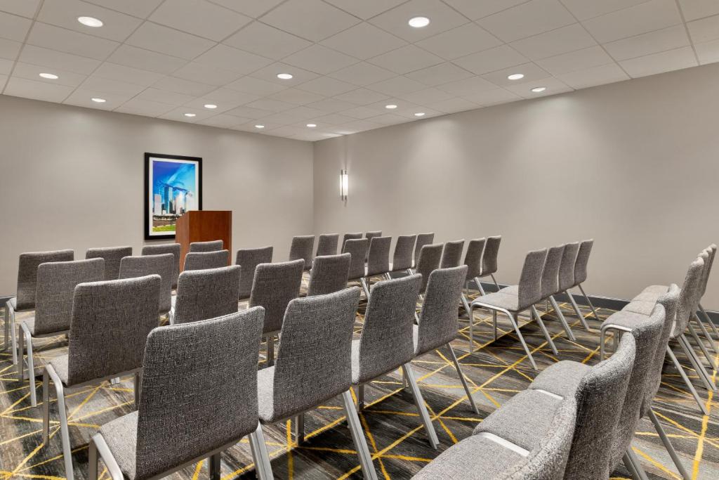 a conference room with rows of chairs and a podium at Holiday Inn Houston Intercontinental Airport by IHG in Houston