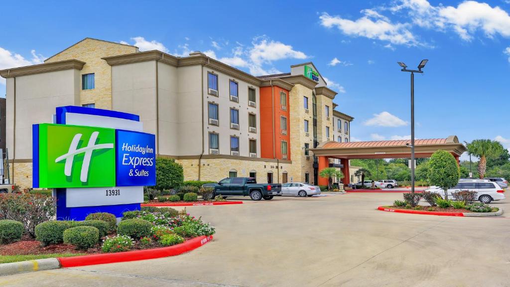 a hotel with a sign in front of a building at Holiday Inn Express & Suites Houston South - Near Pearland, an IHG Hotel in Houston