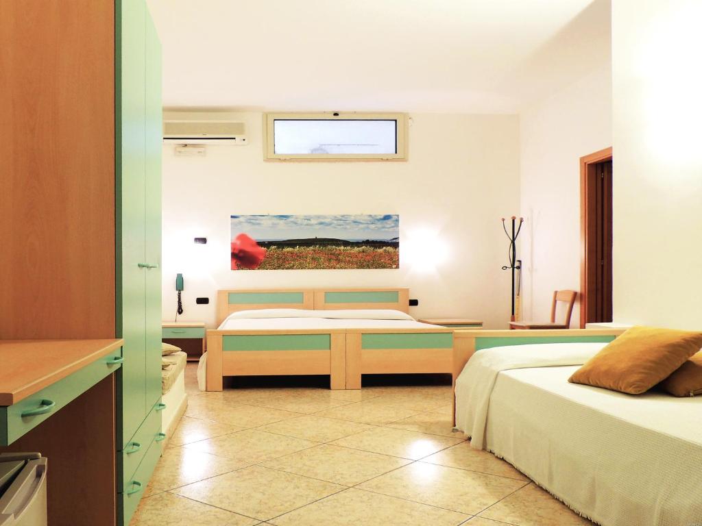 Postel nebo postele na pokoji v ubytování Hotel Porto Badisco