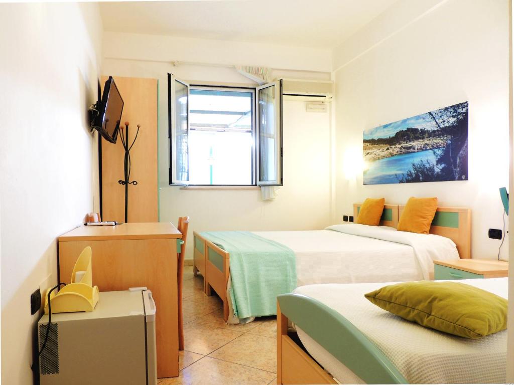 Postel nebo postele na pokoji v ubytování Hotel Porto Badisco