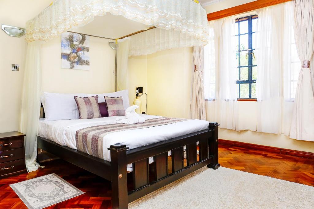 Postel nebo postele na pokoji v ubytování Orchid Homes, Gigiri