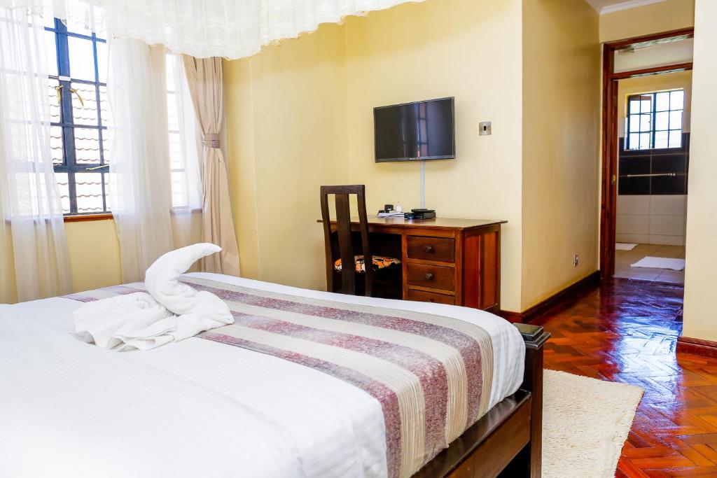 Postel nebo postele na pokoji v ubytování Orchid Homes, Gigiri