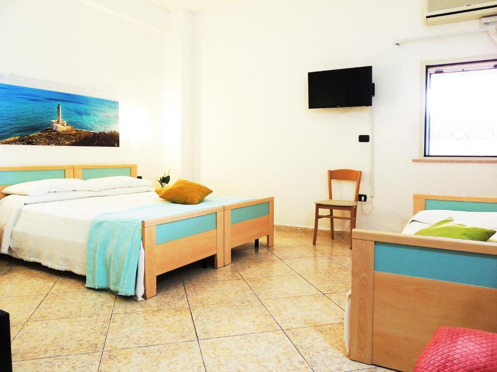 Postel nebo postele na pokoji v ubytování Hotel Porto Badisco