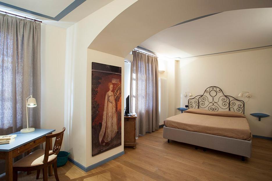 Postel nebo postele na pokoji v ubytování Borromeo Rooms Bed & Living