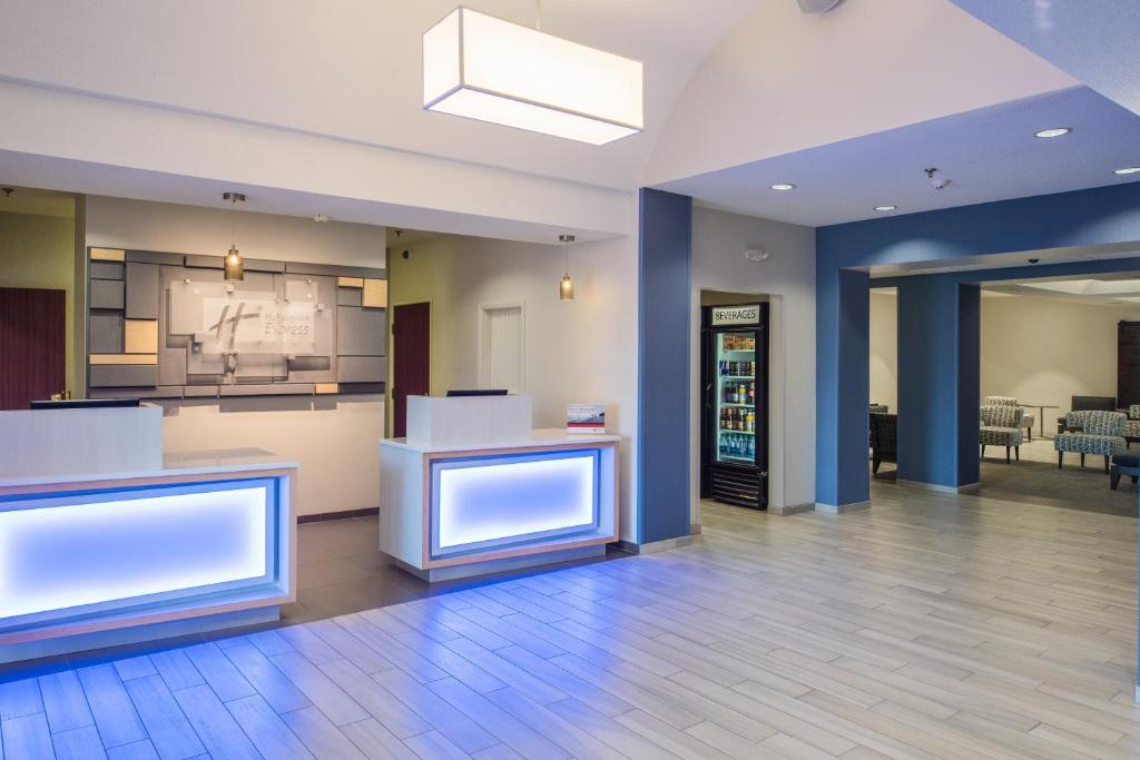 an empty lobby with a kitchen and a dining room at Holiday Inn Express Hotel & Suites Burlington by IHG in Burlington
