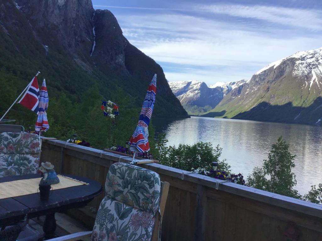 a balcony with a view of a lake and mountains at Iris Vedal in Nauste