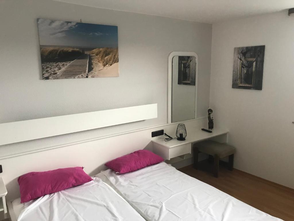 a bedroom with a bed and a desk and a mirror at Wappensaal Dhaun in Hochstetten-Dhaun