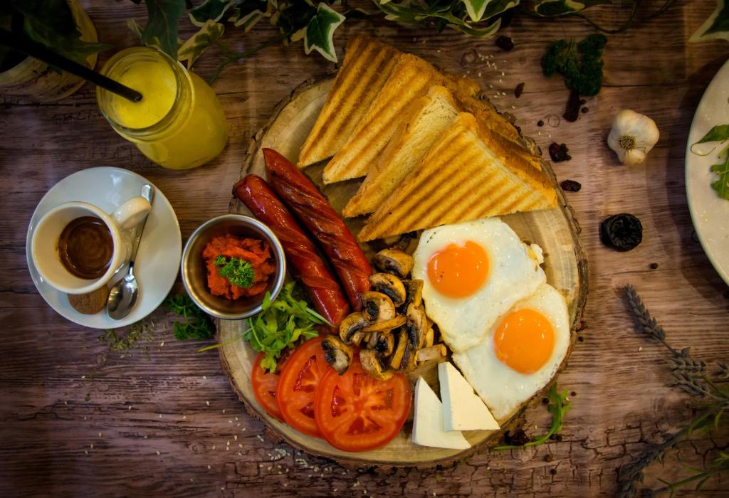 a plate of breakfast food with eggs bread and toast at Hotel Srbija Garden-FREE PARKING in Belgrade