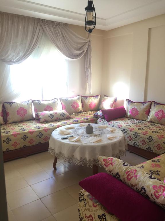 a living room with a couch and a table at ocean view apartment in Rabat