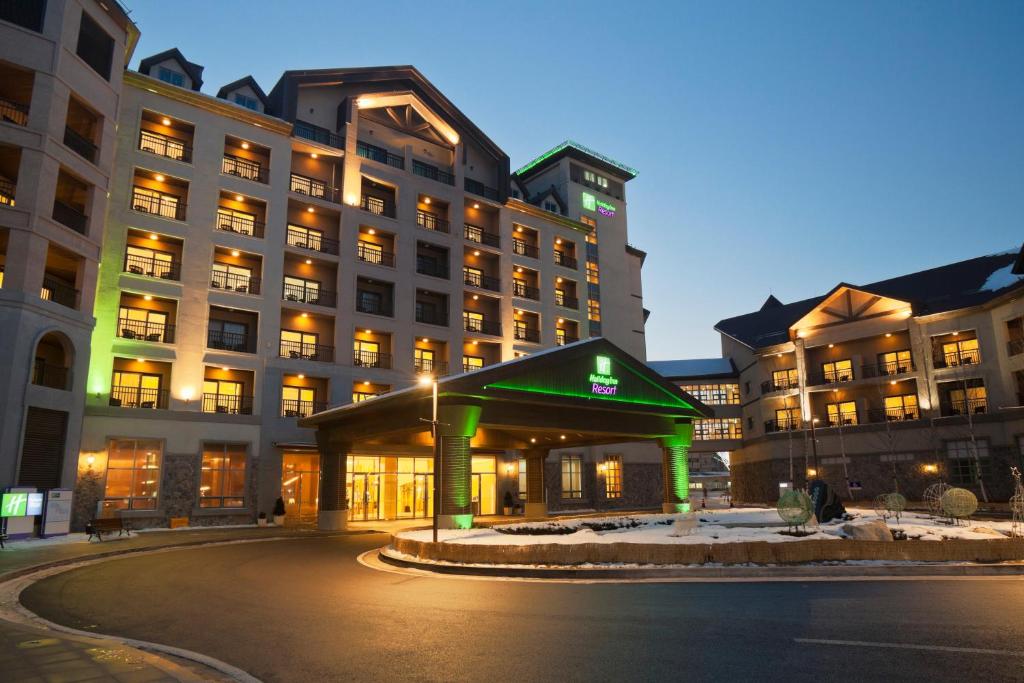 a large building with green lights in front of it at Holiday Inn Resort Alpensia Pyeongchang, an IHG Hotel in Pyeongchang