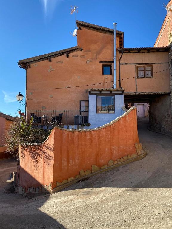 an orange fence in front of a building at CASA LA JUDERÍA in Gea de Albarracín