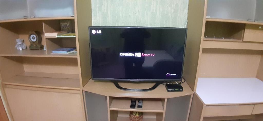 a television sitting on a stand in a room at Старошишковская улица, 7 квартира 142 Апартаменты in Kharkiv