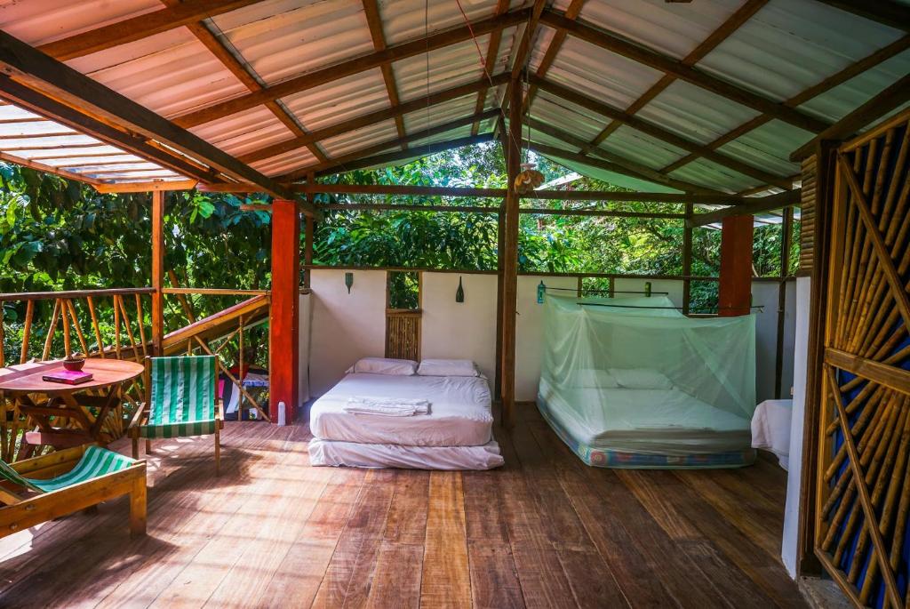 a bedroom in a tent with a bed and a table at Ecocabaña Rosa María in Sapzurro