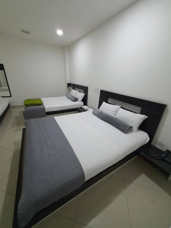 Postel nebo postele na pokoji v ubytování Hotel Laureles Park
