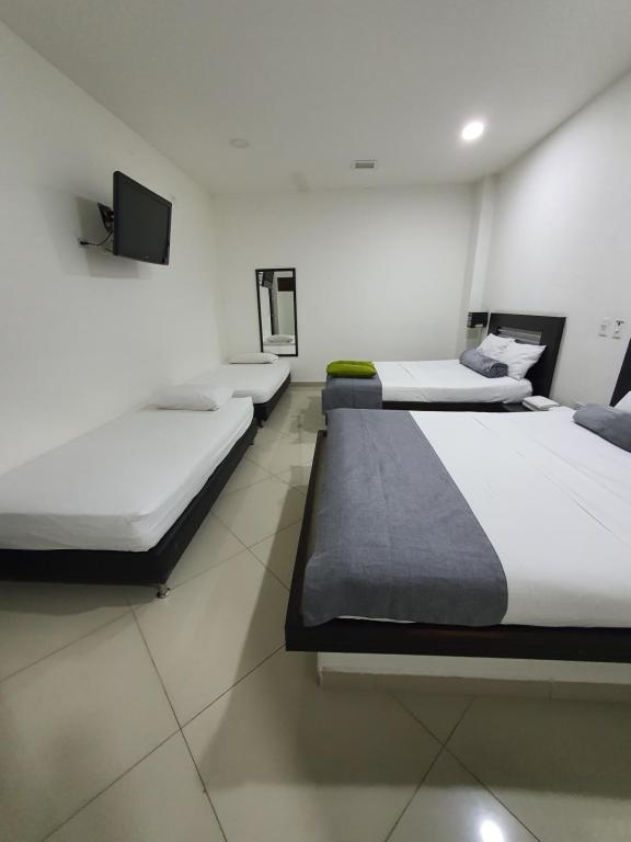 Postel nebo postele na pokoji v ubytování Hotel Laureles Park