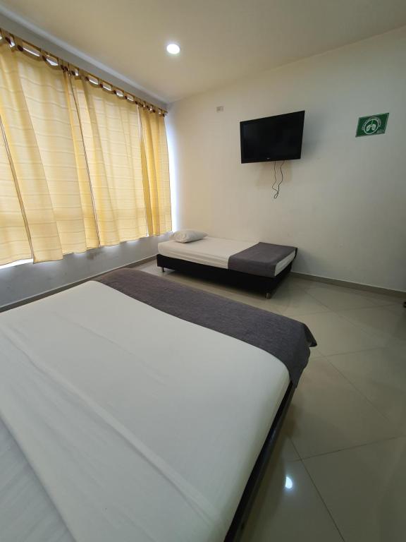 TV a/nebo společenská místnost v ubytování Hotel Laureles Park