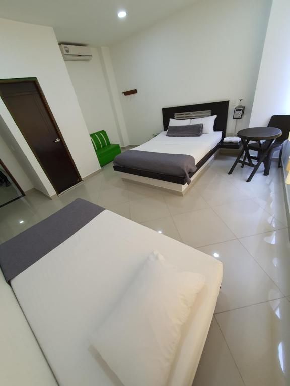 Postel nebo postele na pokoji v ubytování Hotel Laureles Park