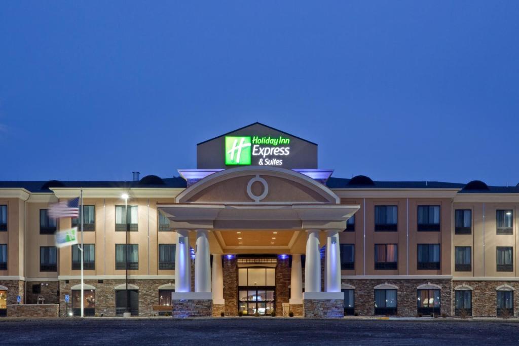 a hotel with a sign on the front of it at Holiday Inn Express Hays by IHG in Hays