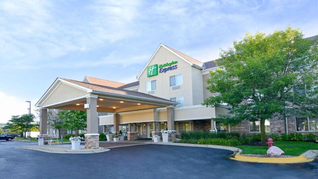 a man sitting in front of a hotel at Holiday Inn Express & Suites Chicago-Deerfield Lincolnshire by IHG in Riverwoods
