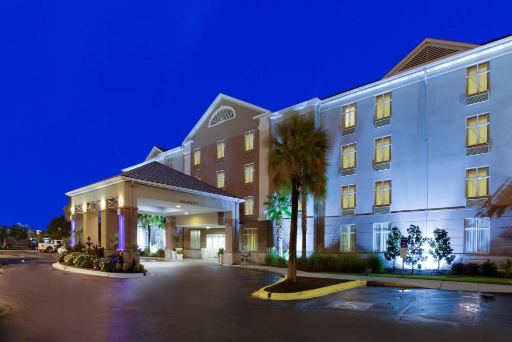 a hotel with a palm tree in front of a building at Holiday Inn Express Hotel & Suites Charleston-Ashley Phosphate, an IHG Hotel in Charleston