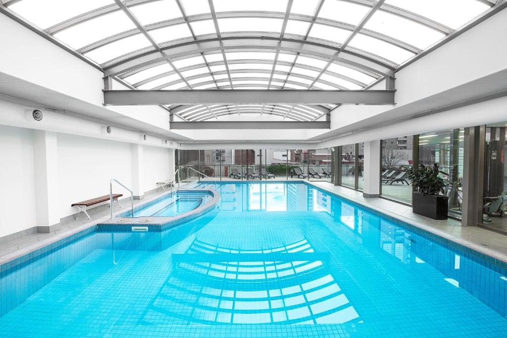a large swimming pool with a glass ceiling at Mantra on Russell in Melbourne